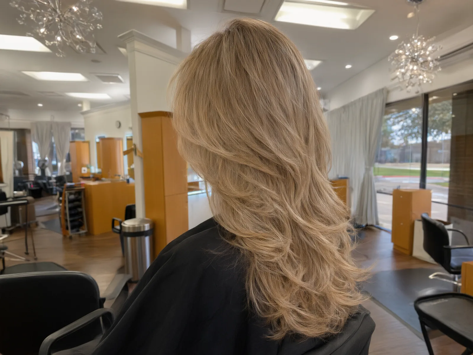 Close-up: bouncy, glossy blowout with movement in the ends