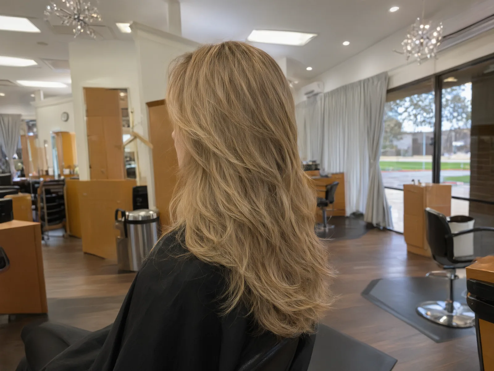 Close-up: bouncy, glossy blowout with movement in the ends