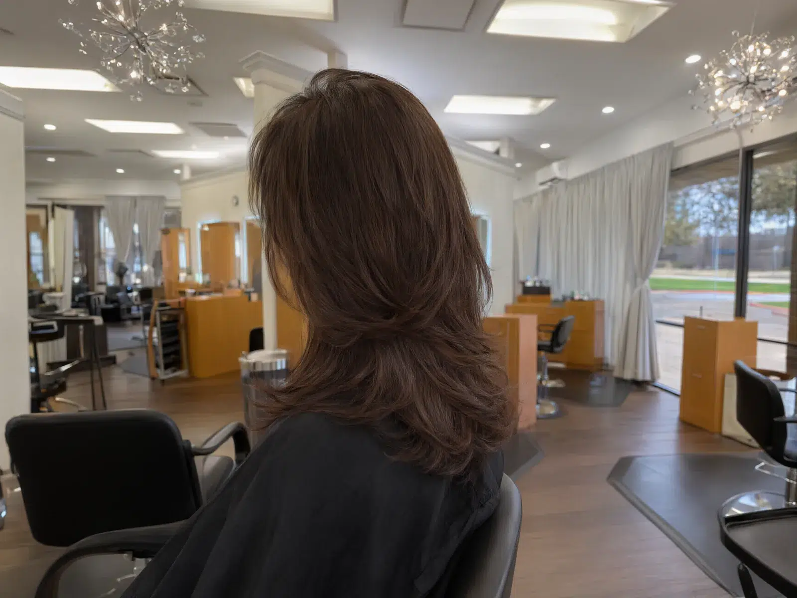 Close-up: bouncy, glossy blowout with movement in the ends