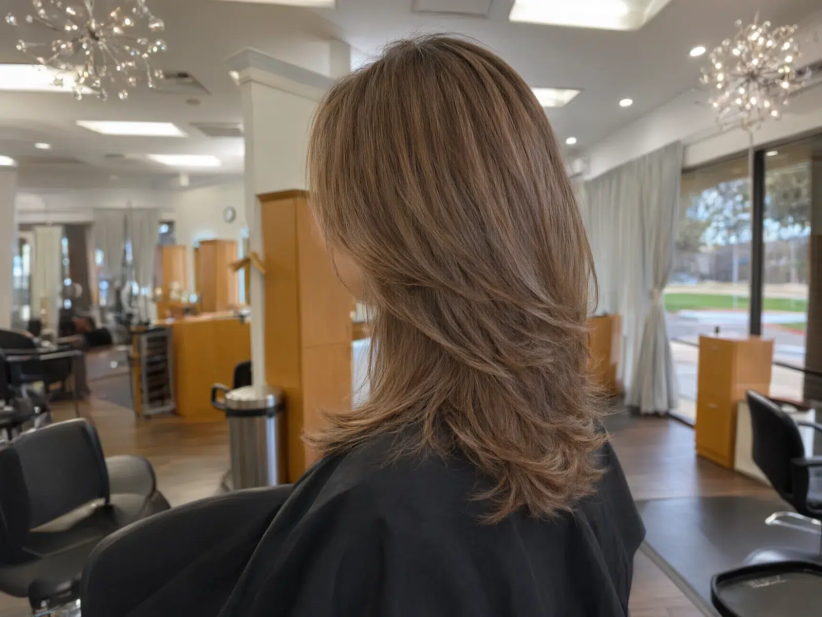 Close-up: bouncy, glossy blowout with movement in the ends
