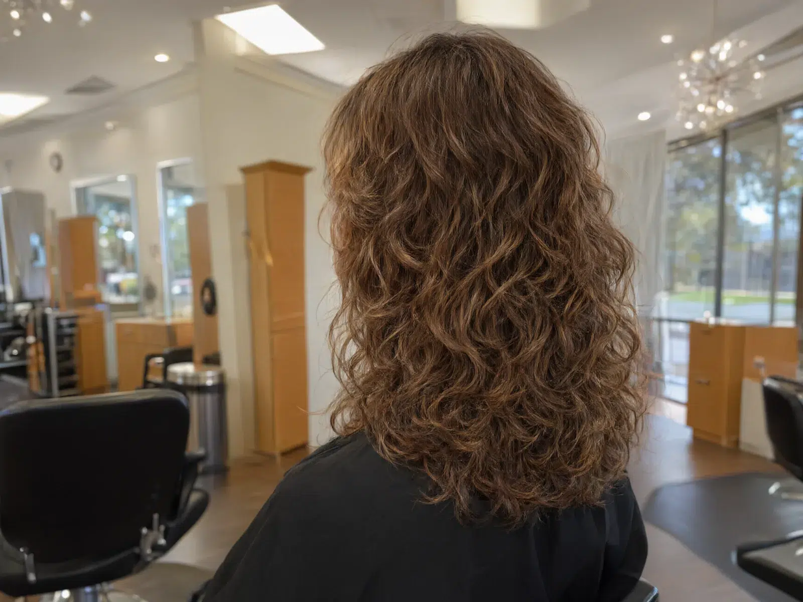 Close-up: defined, healthy curls after a curly cut, natural volume