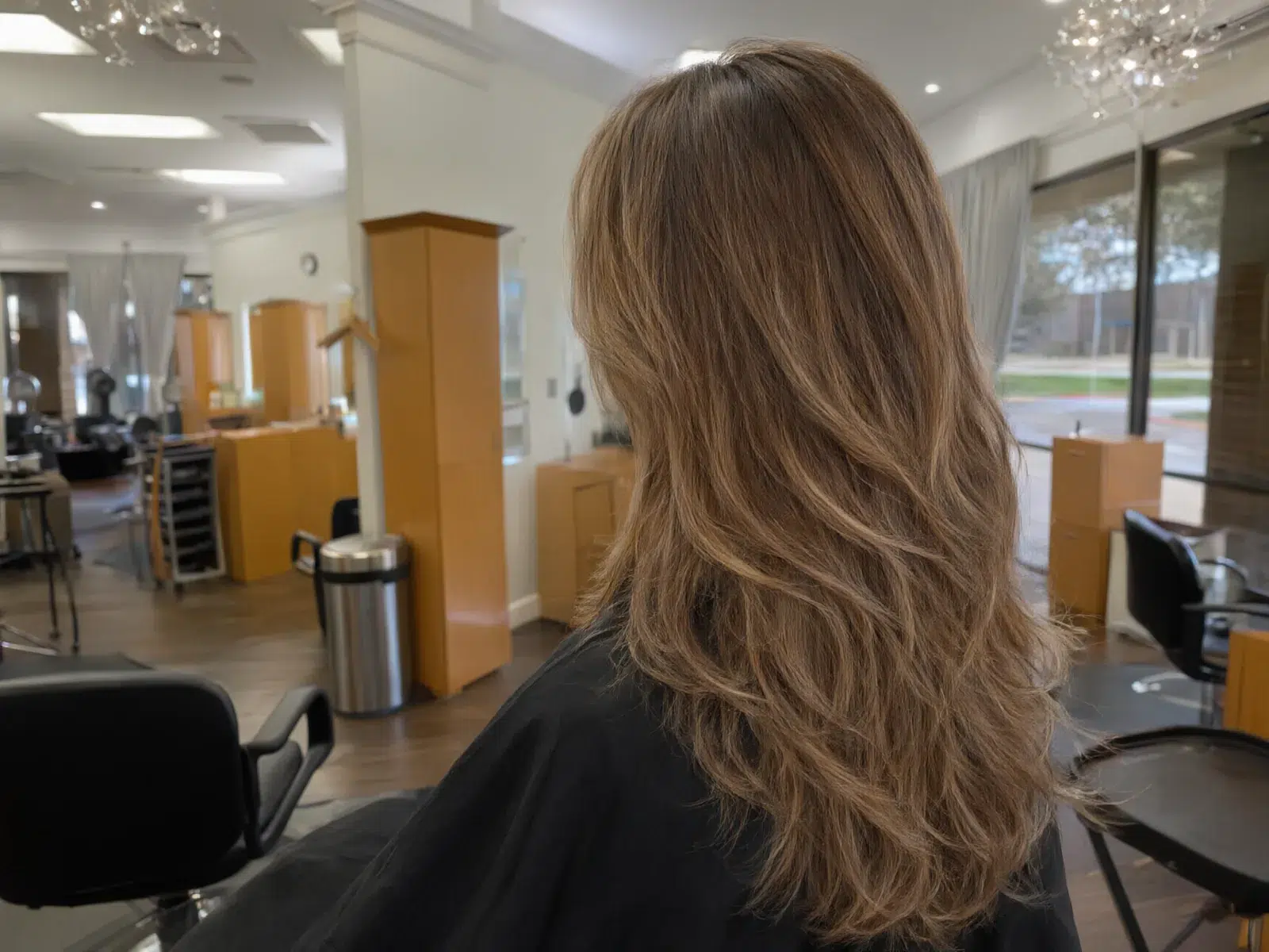Close-up: soft hand-painted balayage in honey and caramel tones, blended at the roots