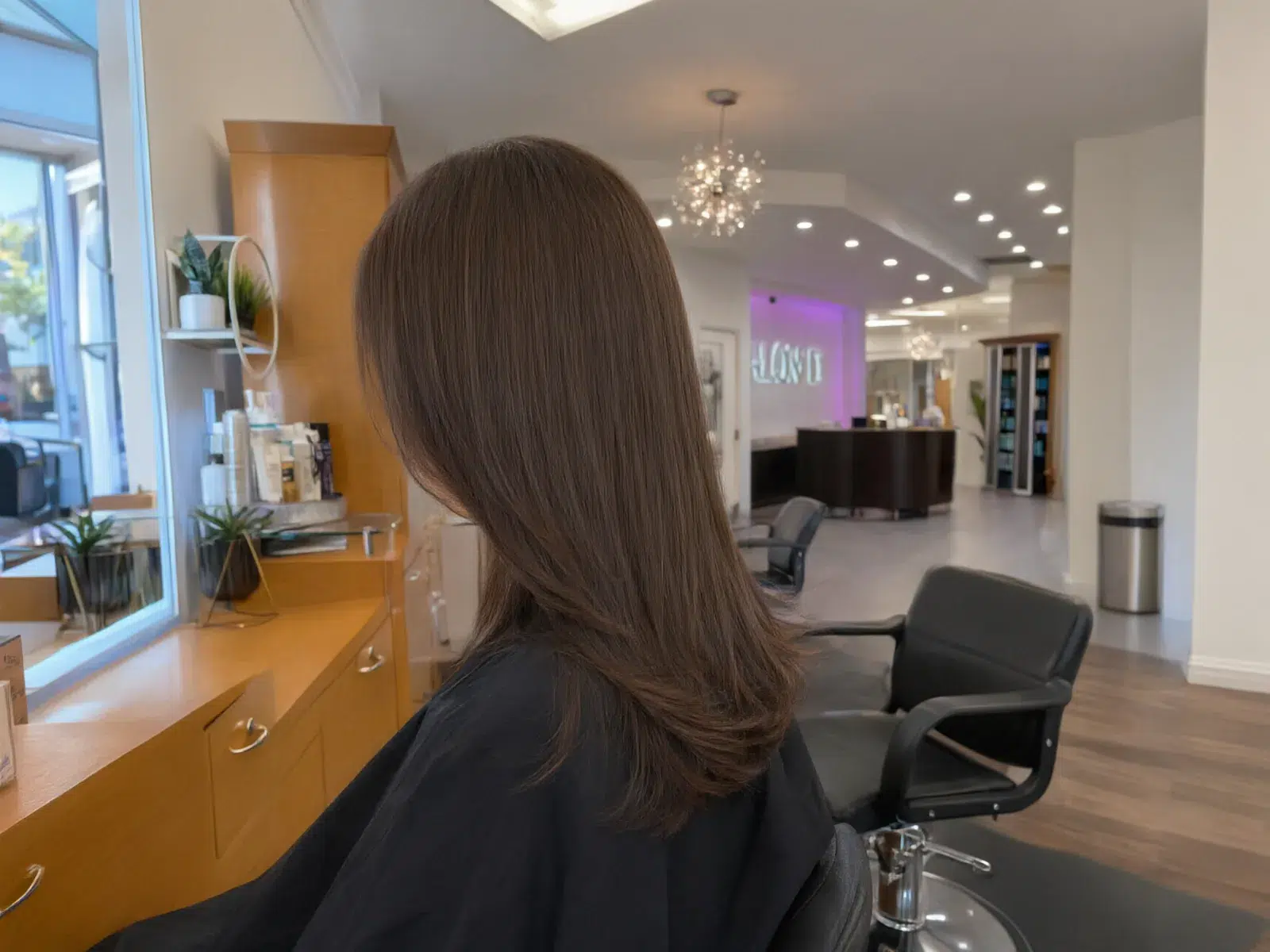 Close-up: straight, sleek, glass-smooth brunette hair after a keratin treatment