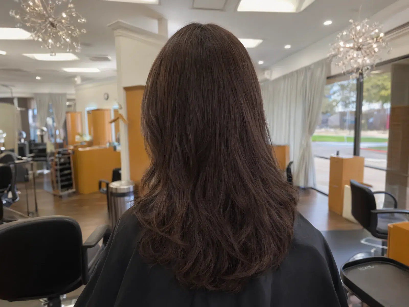 Long, full hair extensions blended seamlessly, soft waves at Salon D in Dallas