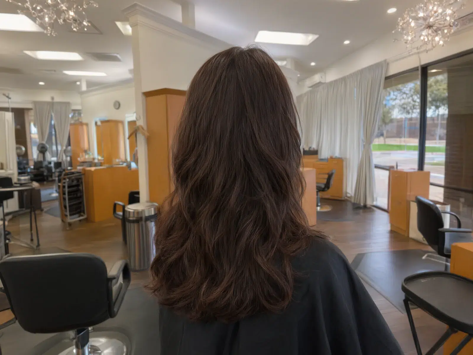 Long, full hair extensions blended seamlessly, soft waves at Salon D in Dallas