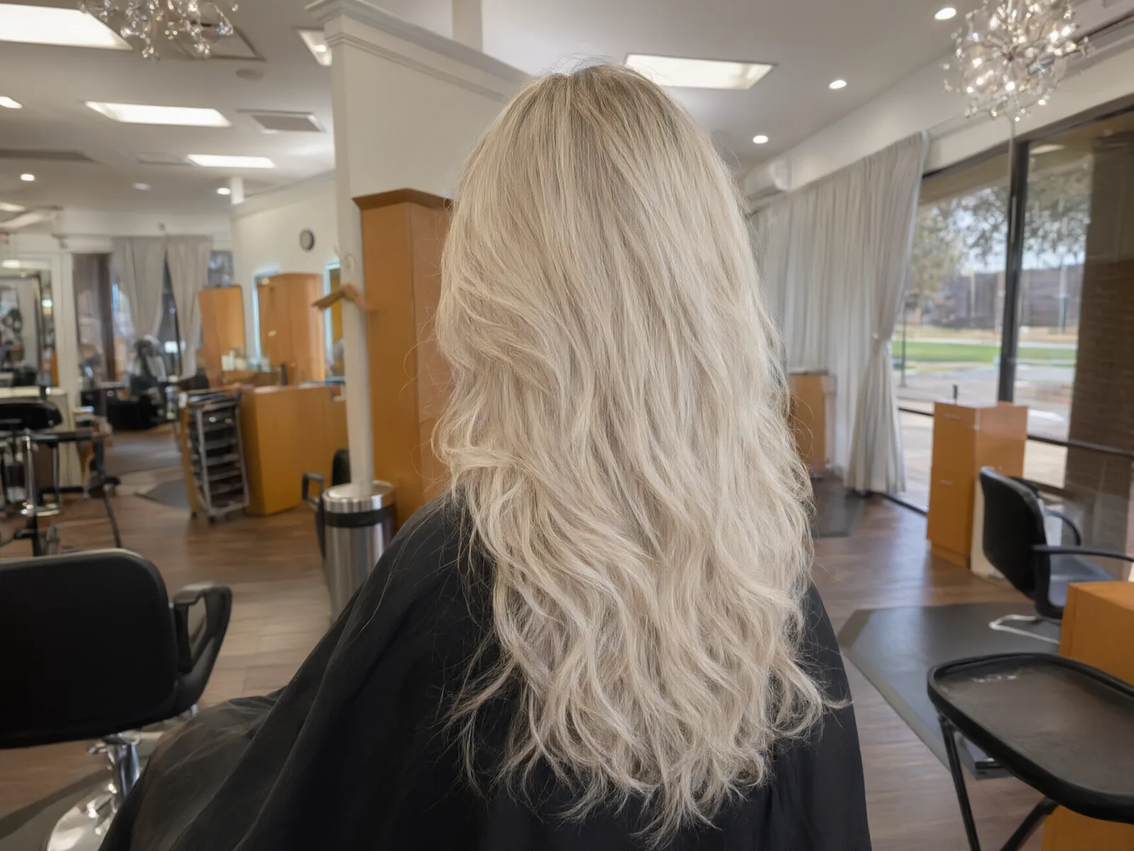 Long, full hair extensions blended seamlessly, soft waves at Salon D in Dallas
