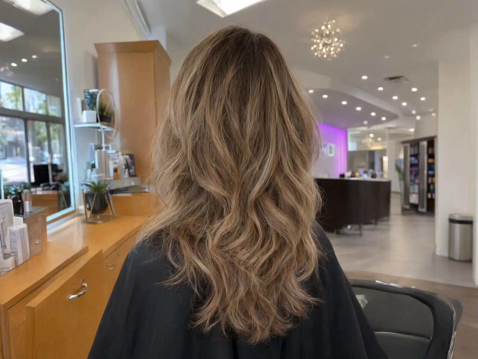 Soft hand-painted balayage in honey and caramel tones, blended at the roots at Salon D in Dallas
